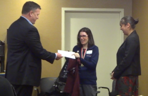 Olympia Moving President Michael Gilmartin presenting Amanda Church with her sponsorship check