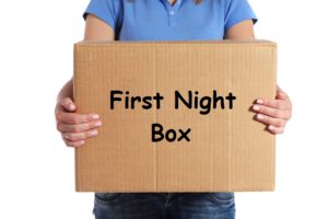 Torso of a female person holding a moving box. All on white background.