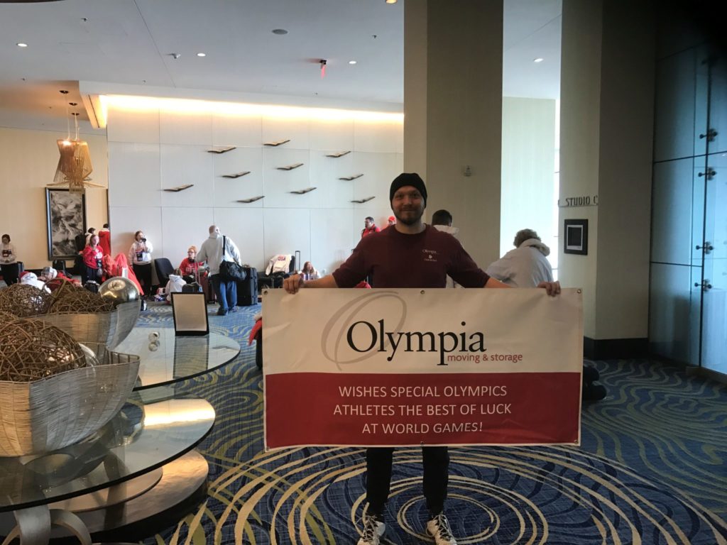 Man holding sign for special olympics