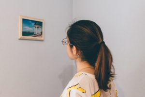 Woman looking at a painting she is going to move