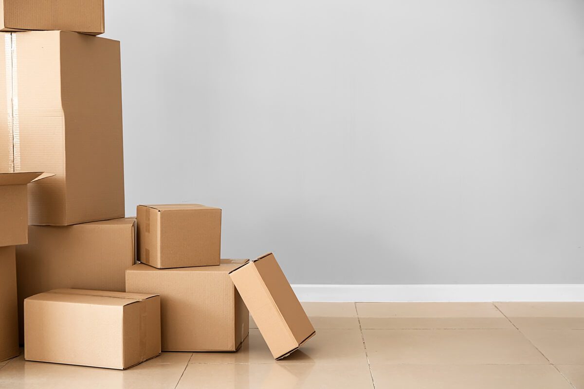 Cardboard boxes near light wall