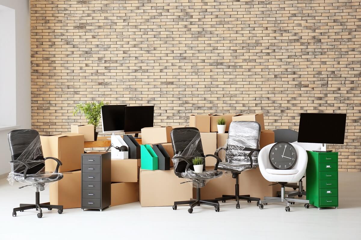 Carton boxes with stuff in empty room